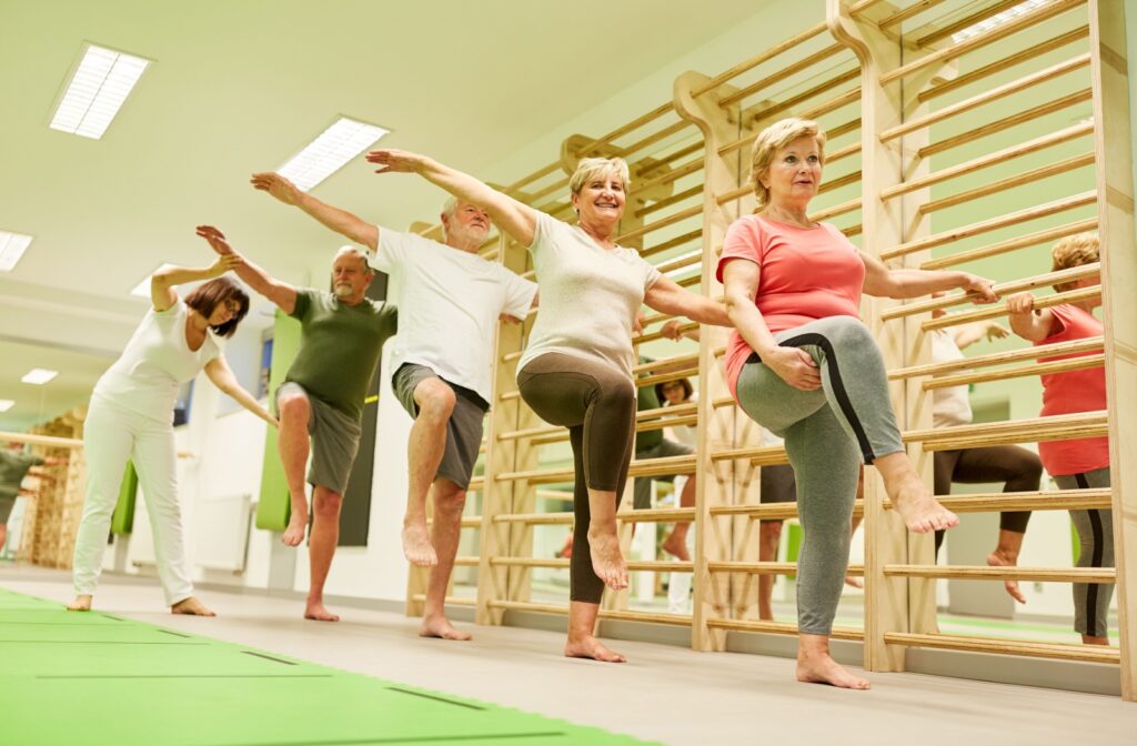 A group of senior residents attend a low-impact exercise class at a senior living community.