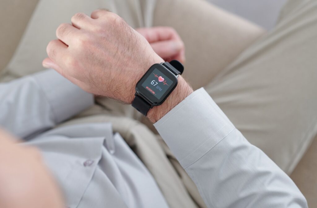 A senior wears a fall detection watch that also measures heart rate